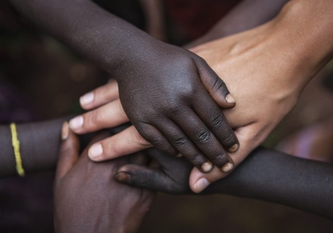 Multiracial human hands in one of African villages, Ethiopia, East Africa